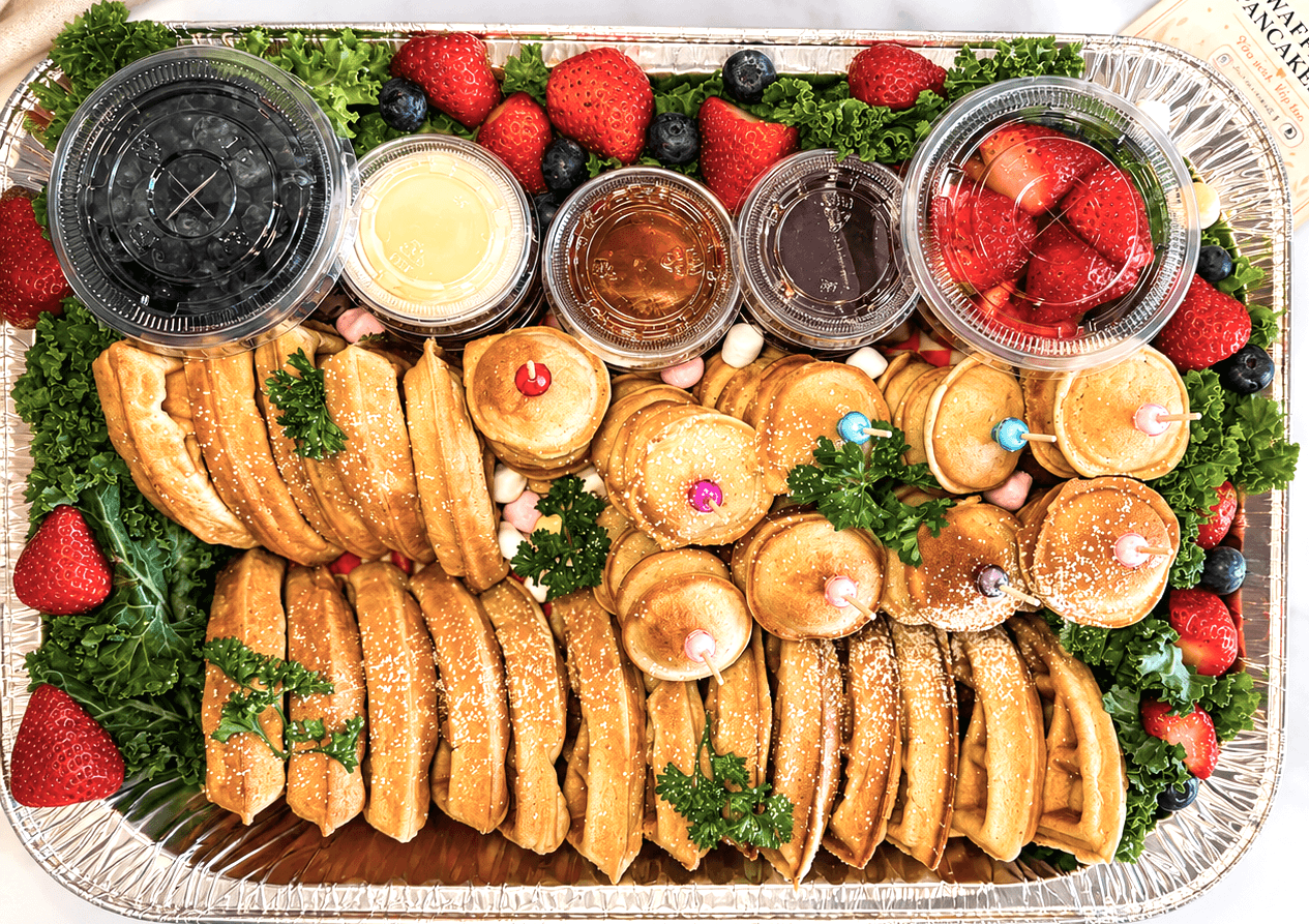 Fresh mini waffles and pancakes arranged as a sharing platter